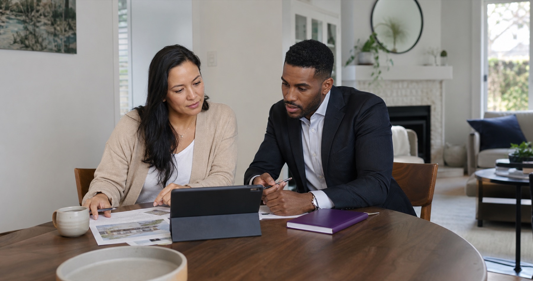 Real estate professional reviewing a customer plan at a desk
